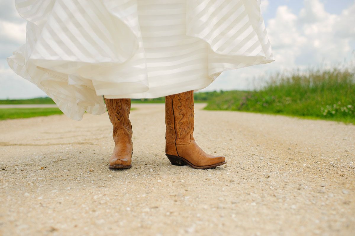 Bride with cowboy wedding boots
