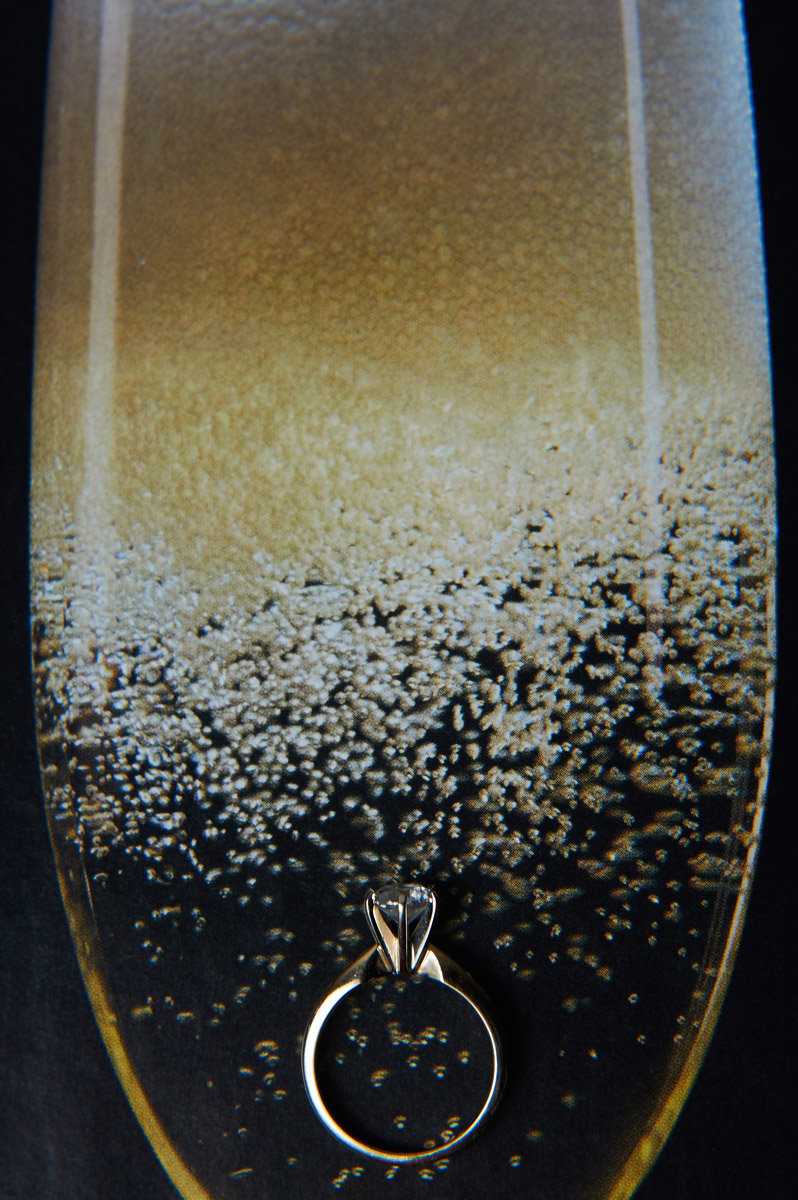 Wedding ring on top of champaigne photo